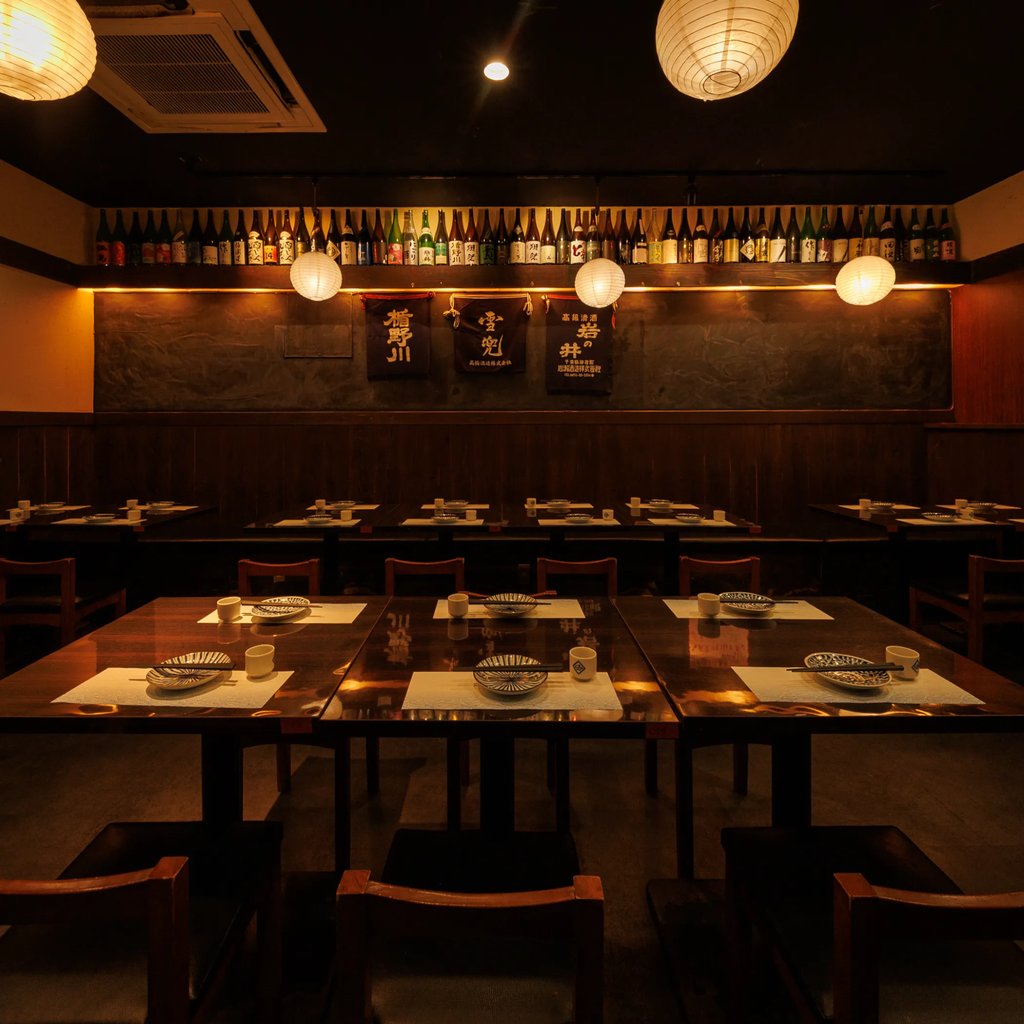 Sake bottles displayed at Nihonshu Genka Sakagura
