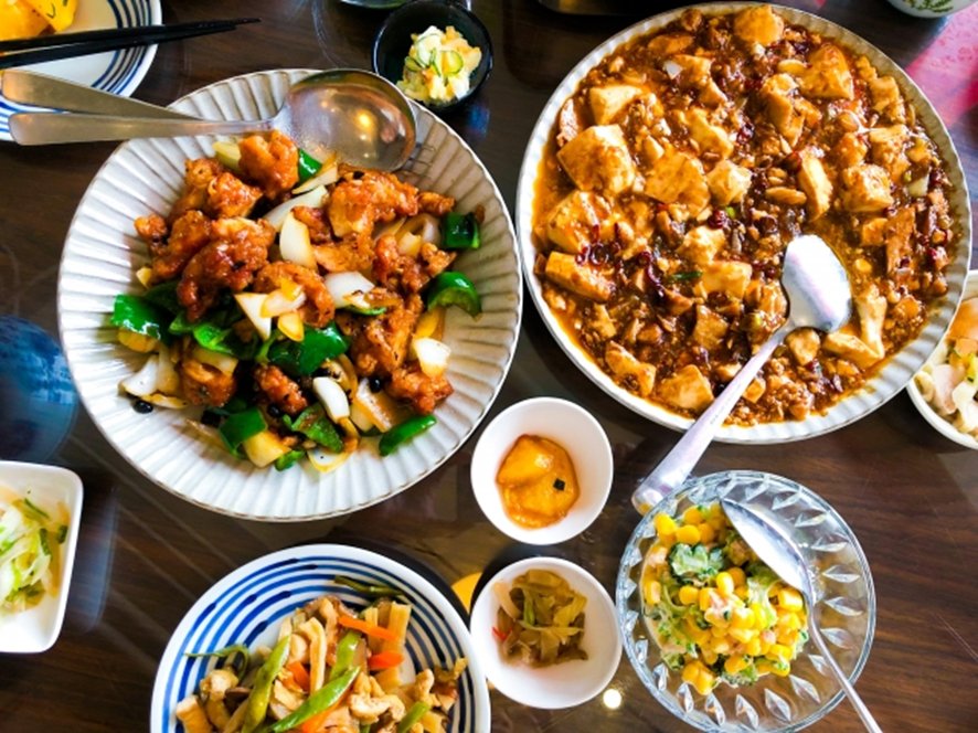 Serving food from shared dish with chopsticks