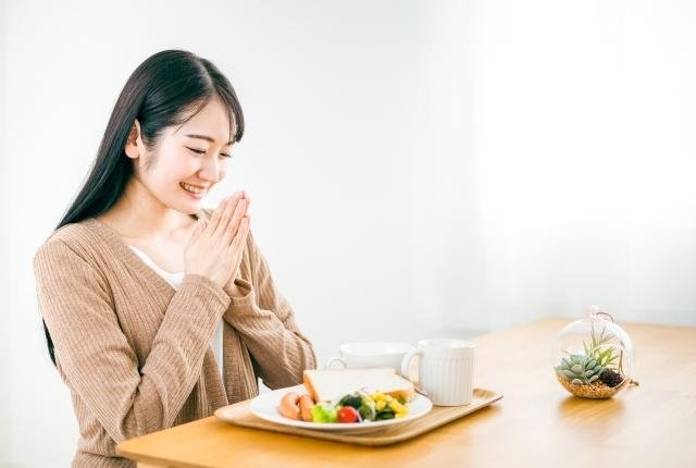 Japanese diners saying itadakimasu before meal