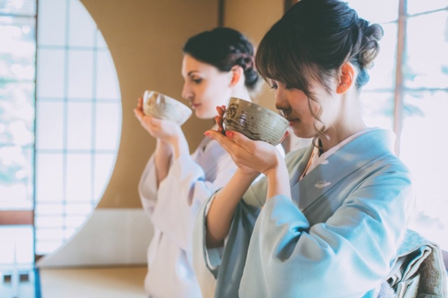 Host preparing matcha tea for guests