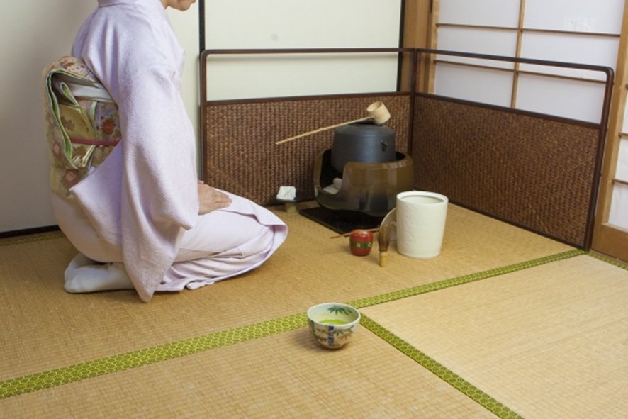 Japanese tea ceremony room displaying seasonal flower arrangement
