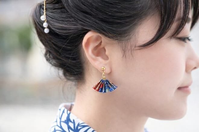 Finished origami jewelry pieces including earrings and necklaces