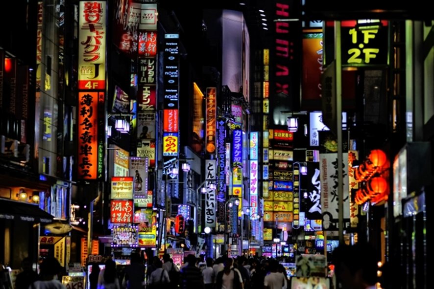 Crowded Shinjuku street at night with pedestrians