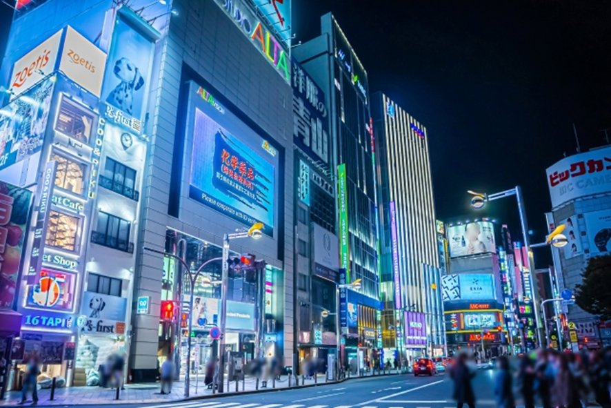Neon lights illuminating Shinjuku streets at night