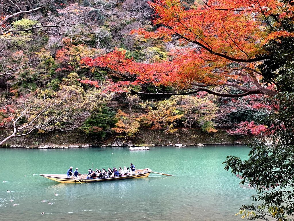 Traditional boat on the Hozu River surrounded by greenery