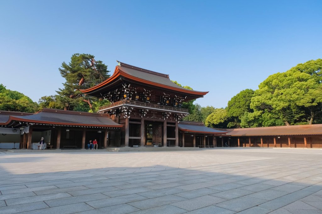 Large torii gate at Meiji Shrine surrounded by forest