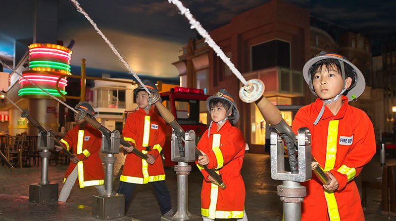Children in firefighter role-play experience at KidZania Tokyo