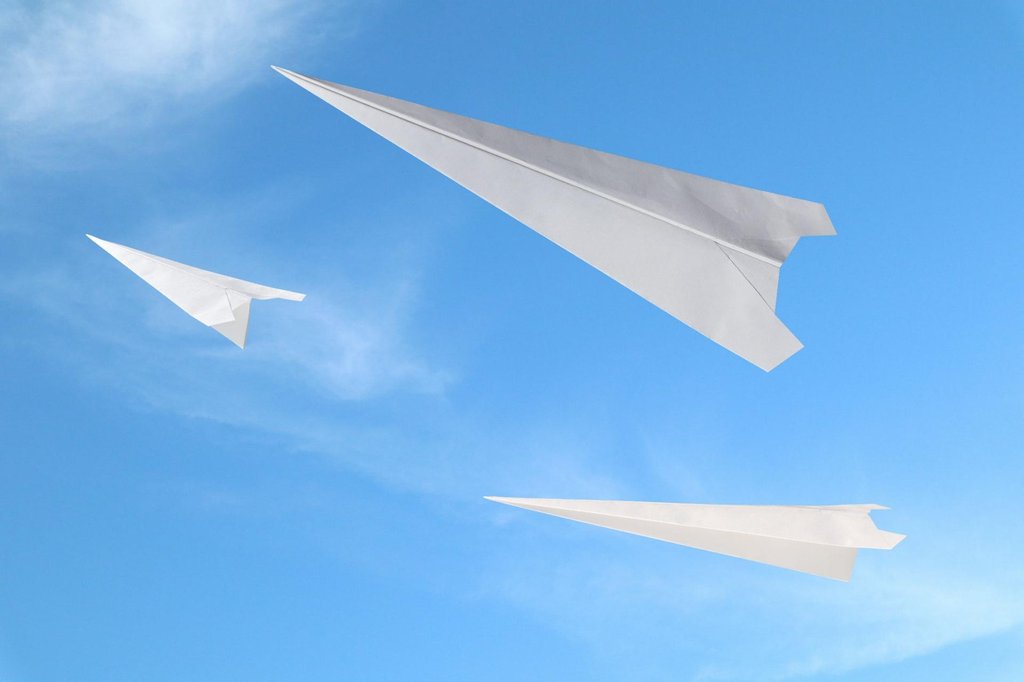 Folded paper airplane ready for flight