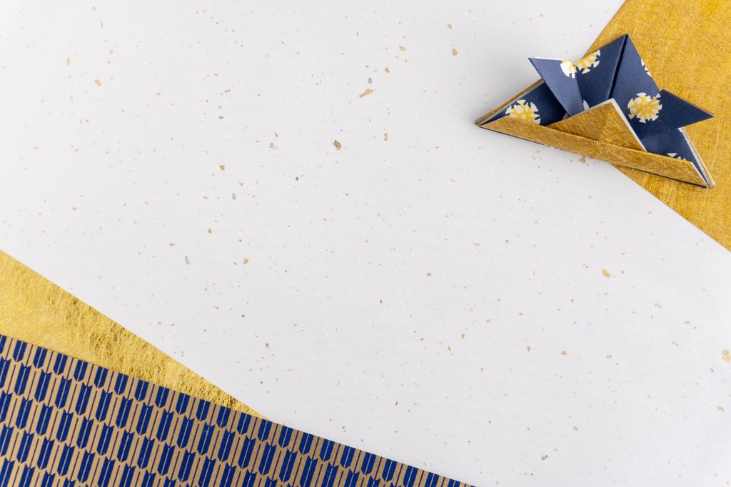Colorful origami paper sheets and folded crane